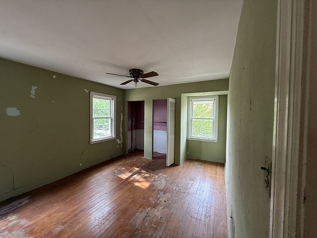 10750 S Ridgeway Ave, Chicago, IL 60655 - unfurnished bedroom featuring wood-type flooring, a ceiling fan, and two closets