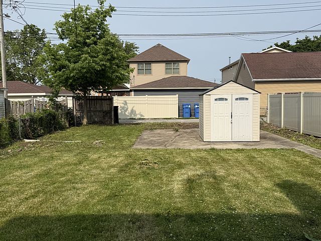 10750 S Ridgeway Ave, Chicago, IL 60655 - fenced backyard with a storage shed and a patio