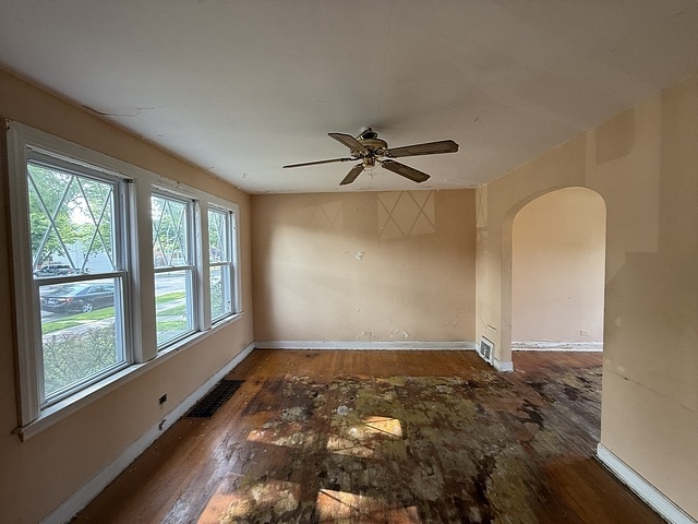 10750 S Ridgeway Ave, Chicago, IL 60655 - empty room featuring arched walkways, wood finished floors, and ceiling fan