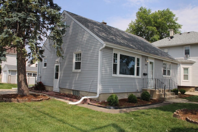 1001 Wilcox St, Joliet, IL 60435 - view of front facade featuring a front yard and roof with shingles