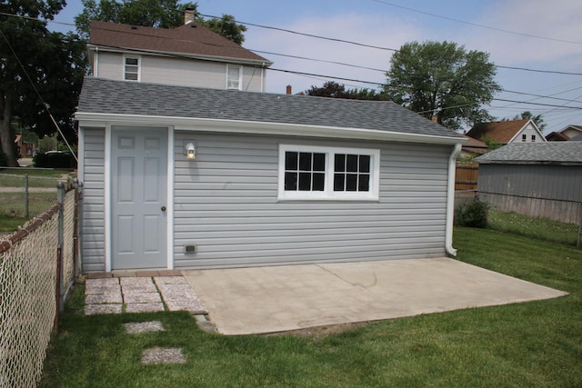 1001 Wilcox St, Joliet, IL 60435 - rear view of house with a fenced backyard, roof with shingles, an outdoor structure, and a patio