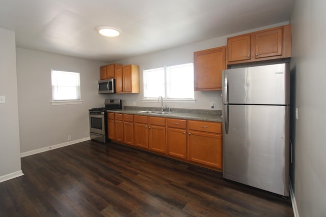 1001 Wilcox St, Joliet, IL 60435 - kitchen featuring appliances with stainless steel finishes, dark wood-style floors, brown cabinets, and dark countertops