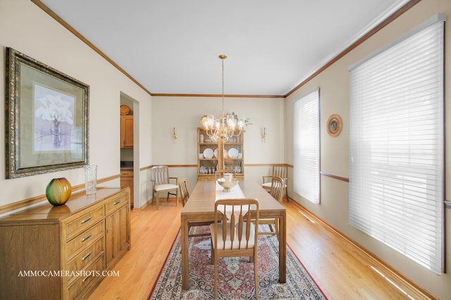 400 Adare Dr, Cary, IL 60013 - dining area featuring crown molding, light wood-style flooring, and a chandelier