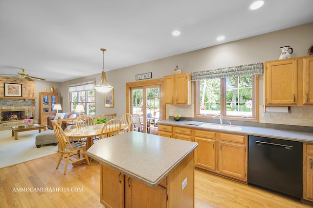 400 Adare Dr, Cary, IL 60013 - kitchen with black dishwasher, a fireplace, light wood finished floors, a center island, and open floor plan