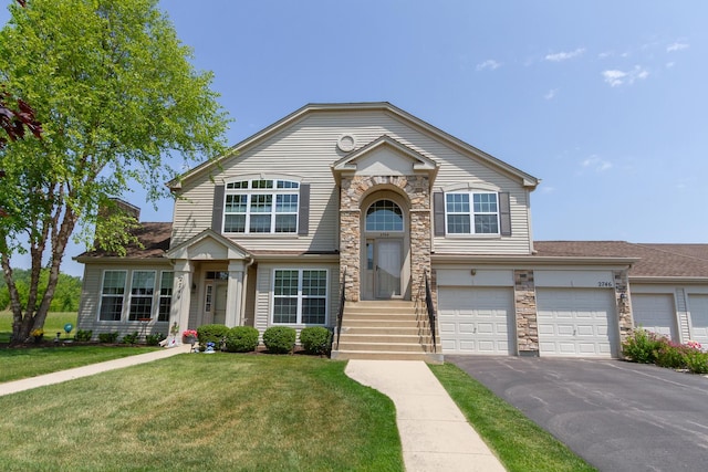 2746 Acorn Ct Unit 2746, West Dundee, IL 60118 - view of front of property with a front yard, stone siding, asphalt driveway, and a garage