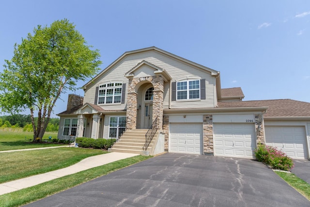 2746 Acorn Ct Unit 2746, West Dundee, IL 60118 - view of front of house with stone siding, driveway, a front lawn, and a garage