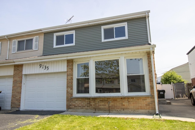 9135 Hollyberry Ave, Des Plaines, IL 60016 - townhome / multi-family property with brick siding, a gate, and an attached garage