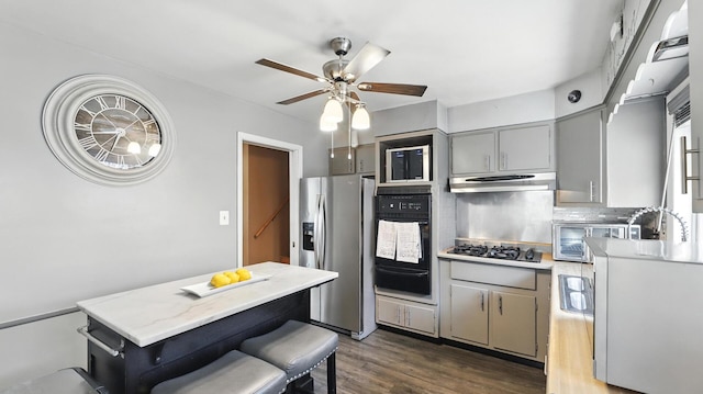 139 Hyde Park Ave, Bellwood, IL 60104 - kitchen featuring stainless steel fridge with ice dispenser, gray cabinetry, oven, a warming drawer, and under cabinet range hood
