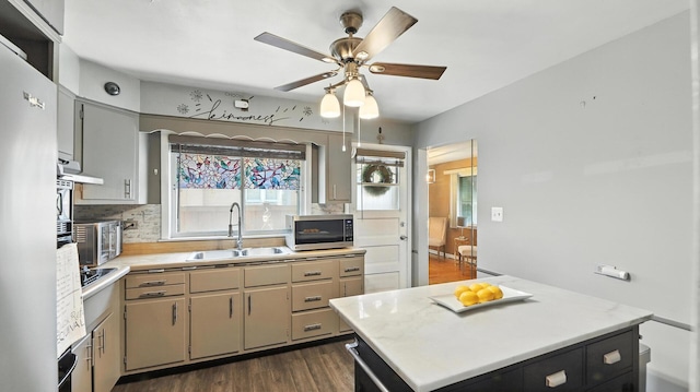 139 Hyde Park Ave, Bellwood, IL 60104 - kitchen with appliances with stainless steel finishes, light countertops, a ceiling fan, decorative backsplash, and dark wood-style floors