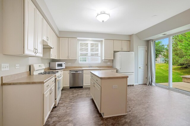 11837 Messiner Dr, Huntley, IL 60142 - kitchen with white appliances, under cabinet range hood, light countertops, and a kitchen island