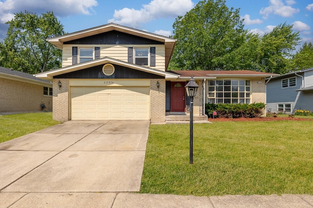 22904 Valley Dr, Richton Park, IL 60471 - split level home with brick siding, concrete driveway, a front lawn, and an attached garage