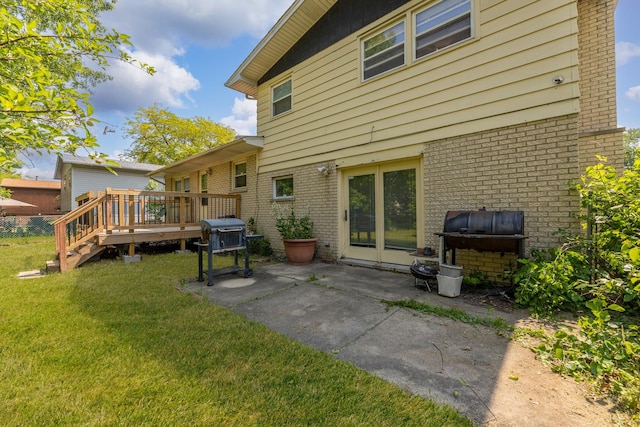 22904 Valley Dr, Richton Park, IL 60471 - rear view of house with brick siding, a deck, a lawn, and a patio