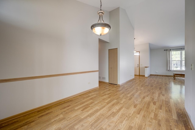 1478 W Flint Ln, Romeoville, IL 60446 - empty room with light wood-style flooring and high vaulted ceiling