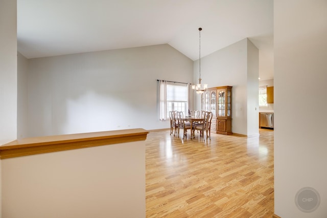 1478 W Flint Ln, Romeoville, IL 60446 - dining area featuring light wood-style flooring, high vaulted ceiling, a chandelier, and plenty of natural light