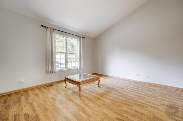 1478 W Flint Ln, Romeoville, IL 60446 - spare room with lofted ceiling and wood finished floors