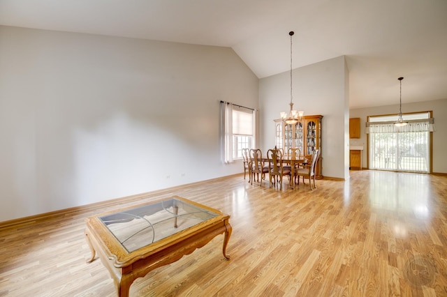 1478 W Flint Ln, Romeoville, IL 60446 - dining space featuring high vaulted ceiling, light wood finished floors, and a chandelier