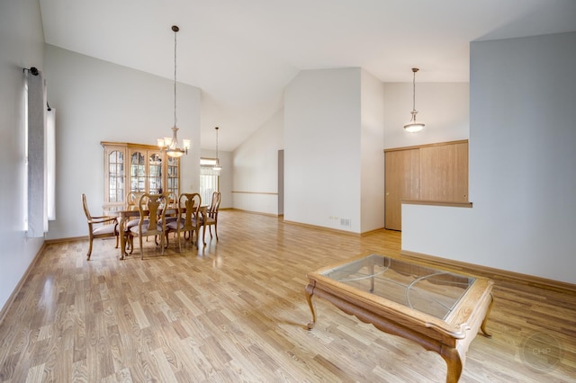 1478 W Flint Ln, Romeoville, IL 60446 - dining space featuring high vaulted ceiling, light wood-style floors, and a chandelier
