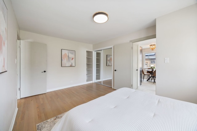 9210 S Mozart Ave, Evergreen Park, IL 60805 - bedroom featuring wood finished floors, a closet, and a chandelier