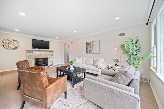 9210 S Mozart Ave, Evergreen Park, IL 60805 - living area featuring recessed lighting, plenty of natural light, light wood-style floors, a stone fireplace, and crown molding