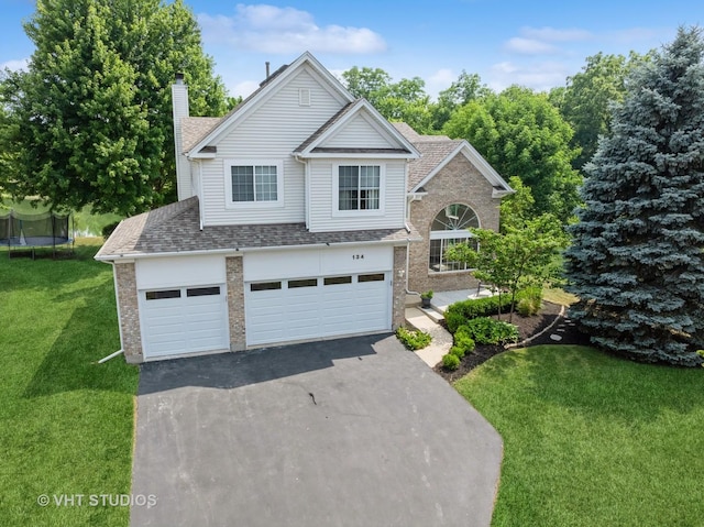 134 S Hankes Rd, Aurora, IL 60506 - traditional-style home with brick siding, a chimney, a front lawn, a trampoline, and driveway