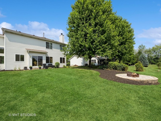134 S Hankes Rd, Aurora, IL 60506 - view of green lawn with an outdoor fire pit