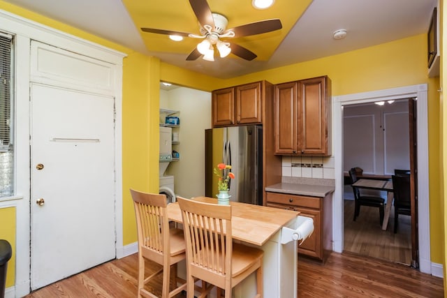 5142 S Greenwood Ave Unit 1, Chicago, IL 60615 - kitchen with freestanding refrigerator, ceiling fan, wood finished floors, and brown cabinetry
