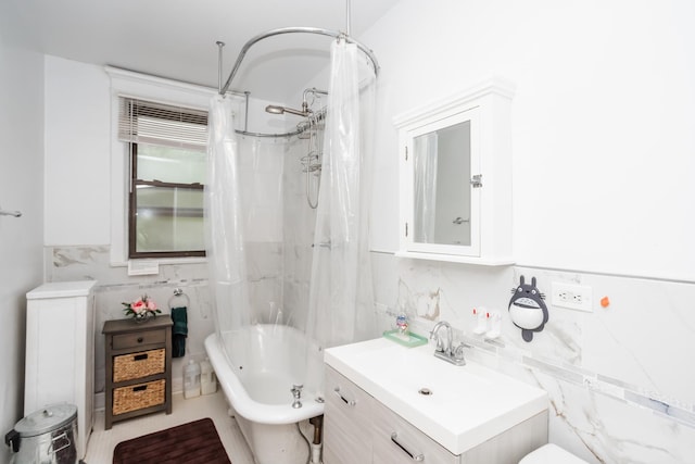5142 S Greenwood Ave Unit 1, Chicago, IL 60615 - bathroom with tile walls, vanity, shower / bath combo with shower curtain, and a wainscoted wall