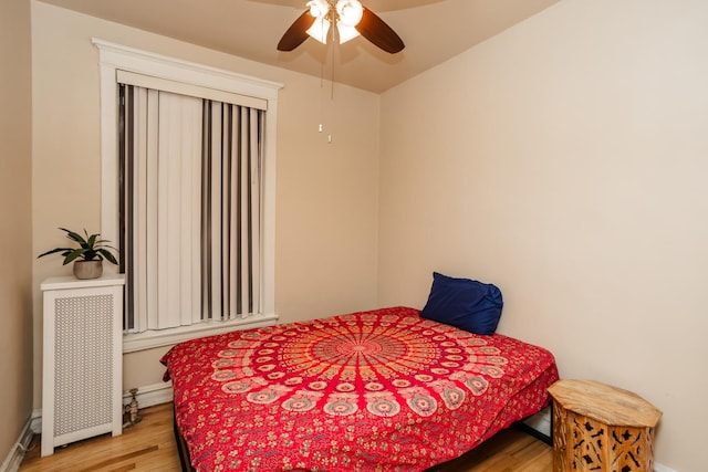 5142 S Greenwood Ave Unit 1, Chicago, IL 60615 - bedroom featuring radiator, wood finished floors, and ceiling fan