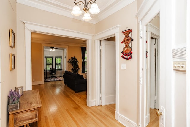 5142 S Greenwood Ave Unit 1, Chicago, IL 60615 - hallway featuring crown molding, light wood finished floors, and a chandelier