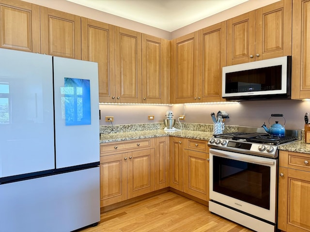 160 S River St Unit 204, Aurora, IL 60506 - kitchen with white appliances, light stone countertops, and light wood-type flooring
