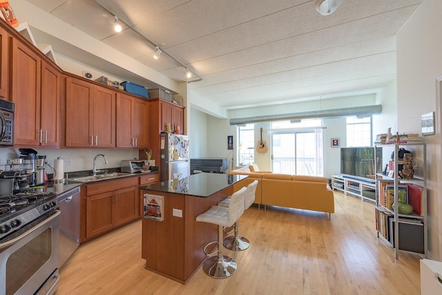 1919 S Michigan Ave Unit 412, Chicago, IL 60616 - kitchen with stainless steel appliances, dark countertops, open floor plan, and light wood-type flooring