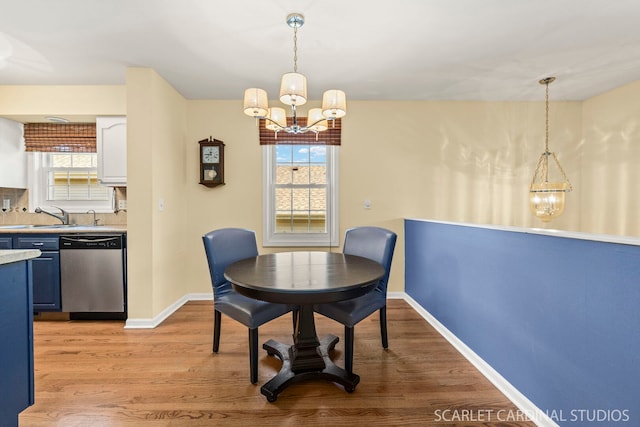 1006 Britta Ln, Geneva, IL 60134 - dining room with a chandelier and light wood-style flooring