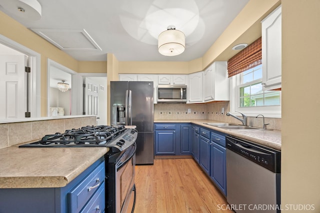 1006 Britta Ln, Geneva, IL 60134 - kitchen with stainless steel appliances, blue cabinetry, white cabinetry, and backsplash