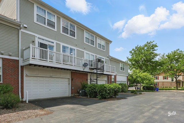 1272 Georgetown Way, Vernon Hills, IL 60061 - view of building exterior featuring asphalt driveway, an attached garage, and stairway