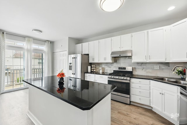 1272 Georgetown Way, Vernon Hills, IL 60061 - kitchen featuring stainless steel appliances, under cabinet range hood, white cabinets, dark countertops, and decorative backsplash
