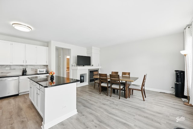 1272 Georgetown Way, Vernon Hills, IL 60061 - kitchen featuring stainless steel dishwasher, white microwave, dark countertops, and a glass covered fireplace