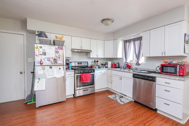 400-02 S Washington St, Braidwood, IL 60408 - kitchen featuring stainless steel appliances, under cabinet range hood, white cabinetry, and light countertops