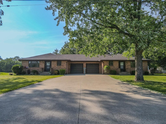 400-02 S Washington St, Braidwood, IL 60408 - view of front of house with a garage, brick siding, driveway, and a front lawn
