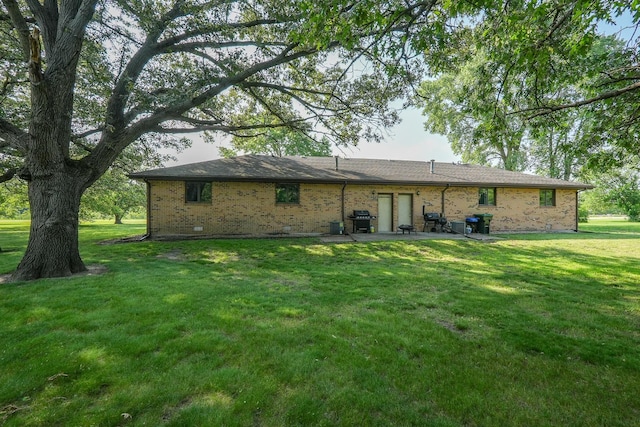 400-02 S Washington St, Braidwood, IL 60408 - rear view of house with a yard, brick siding, and a patio