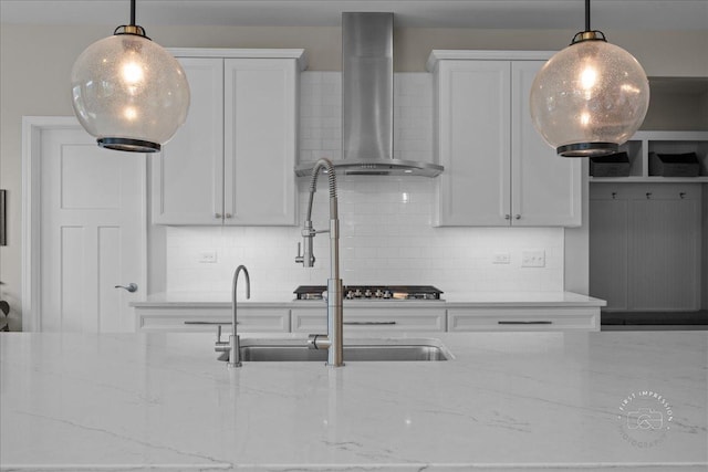340 Hamilton Rd, Saint Charles, IL 60175 - kitchen featuring wall chimney range hood, backsplash, light stone counters, and decorative light fixtures