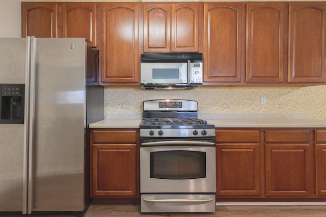8126 Concord Ln Unit A, Justice, IL 60458 - kitchen with stainless steel appliances, light countertops, and brown cabinetry