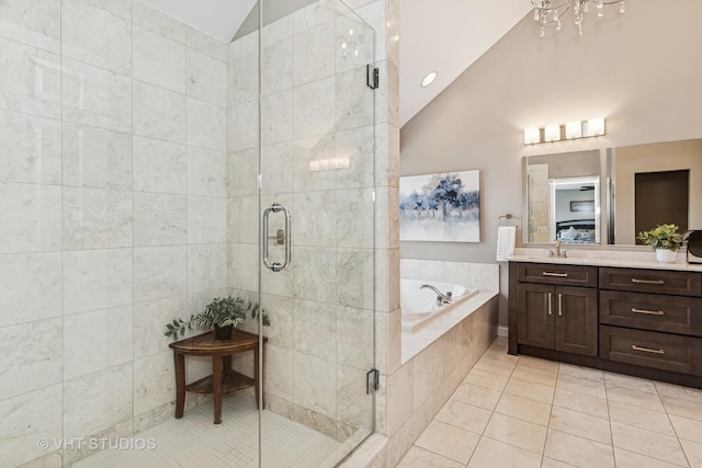 2 E Prairie Ct, Hawthorn Woods, IL 60047 - full bathroom featuring vaulted ceiling, tile patterned flooring, vanity, a bath, and a stall shower