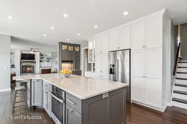 2 E Prairie Ct, Hawthorn Woods, IL 60047 - kitchen featuring gray cabinetry, appliances with stainless steel finishes, dark wood finished floors, a large island, and ceiling fan