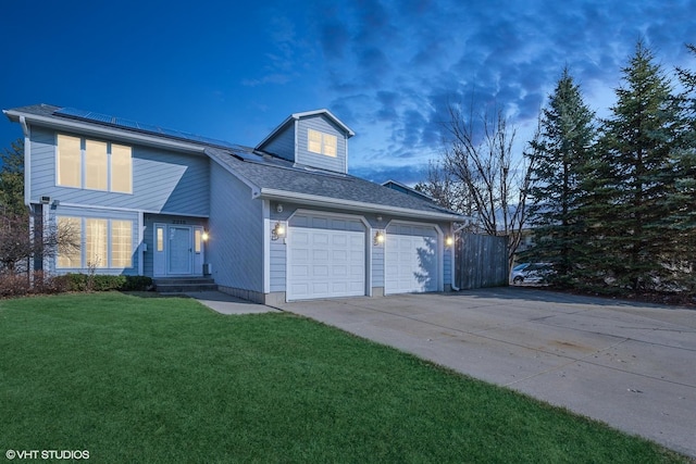2215 Yeoman St, Waukegan, IL 60087 - view of front of home with concrete driveway, roof mounted solar panels, a garage, and a shingled roof