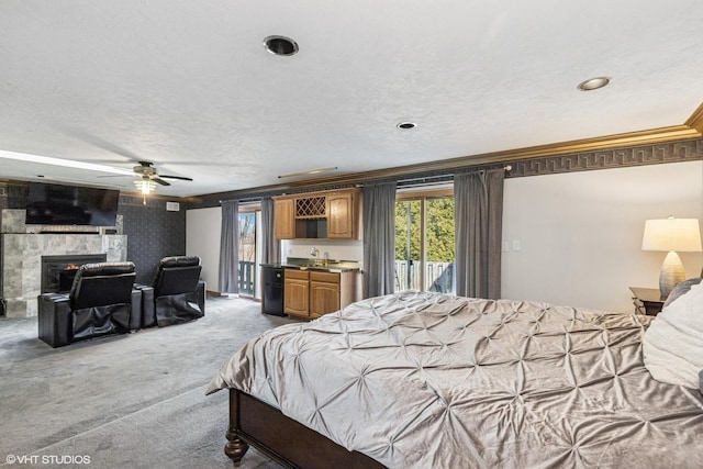 2215 Yeoman St, Waukegan, IL 60087 - carpeted bedroom with access to exterior, bar with sink, ornamental molding, a tiled fireplace, and a textured ceiling