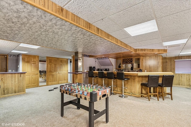 2215 Yeoman St, Waukegan, IL 60087 - recreation room with a bar, light carpet, wood walls, and a drop ceiling