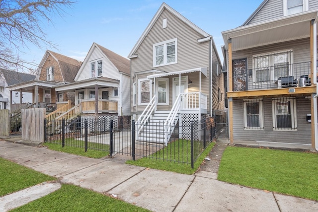 6920 S Laflin St, Chicago, IL 60636 - shotgun-style home with covered porch, a fenced front yard, and a gate