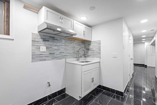 6920 S Laflin St, Chicago, IL 60636 - kitchen with exhaust hood, dark marble finish flooring, white cabinetry, backsplash, and recessed lighting