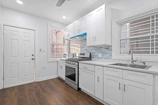 6920 S Laflin St, Chicago, IL 60636 - kitchen featuring stainless steel gas range oven, tasteful backsplash, white cabinetry, light countertops, and dark wood-type flooring