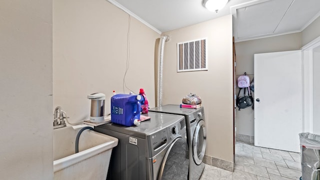 36 Monee Rd, Park Forest, IL 60466 - laundry room with washer and clothes dryer, crown molding, and light stone finish flooring